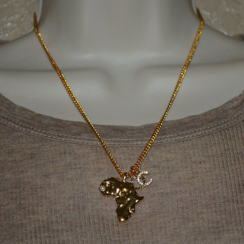 NWOT Chanel 2023 Gold Plated Faux Pearl & Strass Africa CC Pendant Necklace